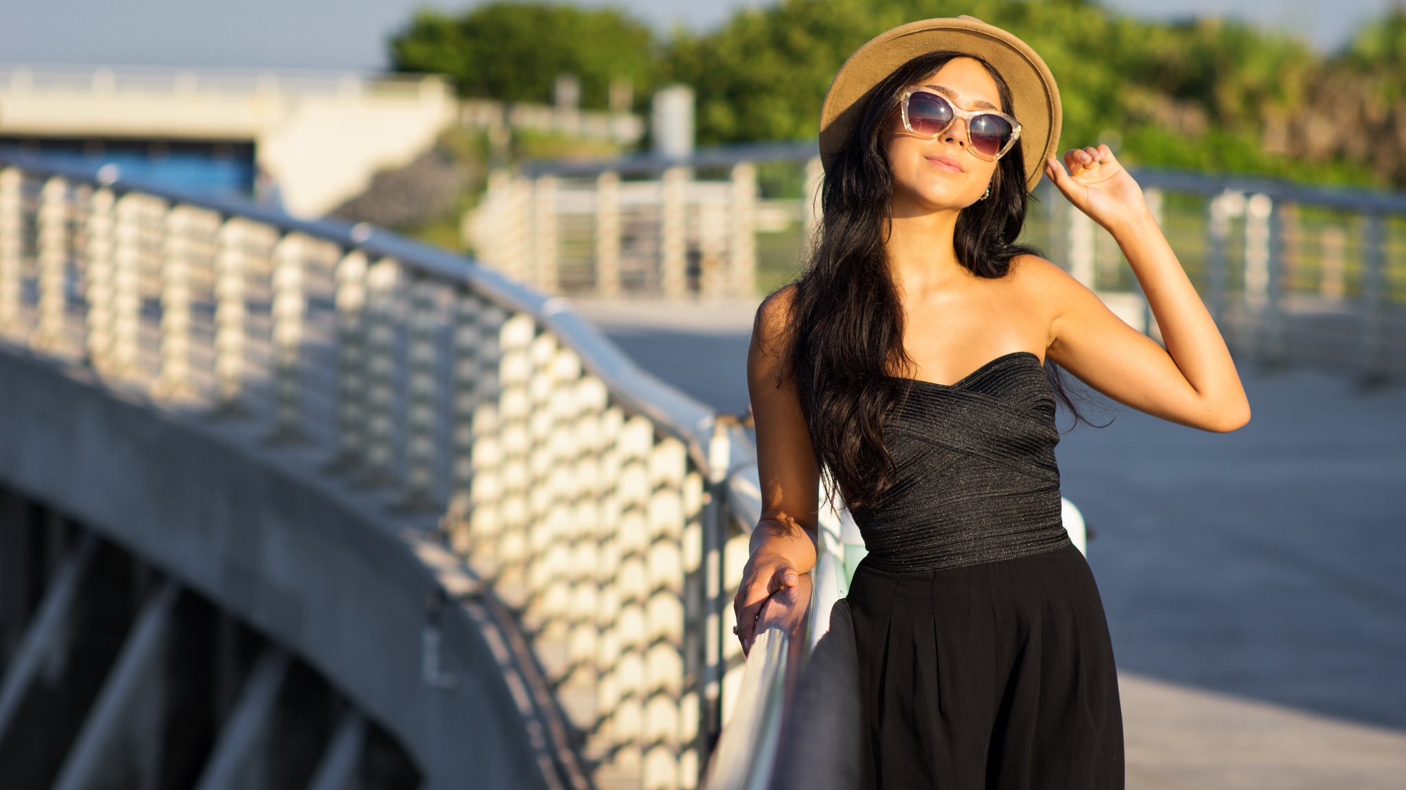 Image: Girl, brunette, hat, glasses, dress, black, style, sun rays, sunset, bridge, walk, posing, sun rays