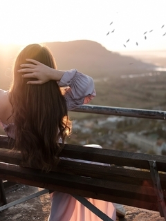 Image: Girl, brunette, long hair, sitting, back, bench, sunset, flock of birds, nature