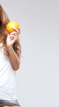 Image: Girl, blonde, smile, hair, holding, orange, tangerine