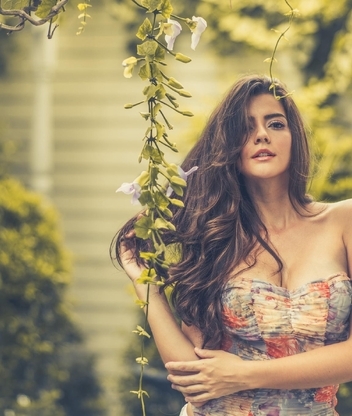 Image: girl, posing, dress, long hair, plant, flowers