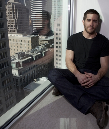 Image: Jake Gyllenhaal, actor, man, sitting, window sill, skyscraper, building