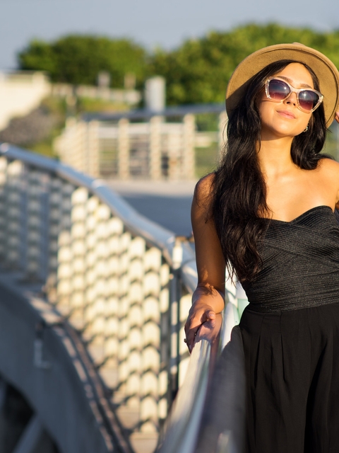 Image: Girl, brunette, hat, glasses, dress, black, style, sun rays, sunset, bridge, walk, posing, sun rays