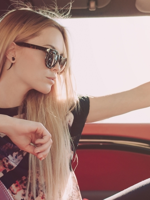Image: Blonde girl, glasses, steering wheel, interior, car
