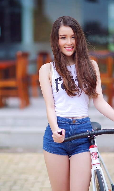 Image: Girl, smile, bike, denim shorts, restaurant