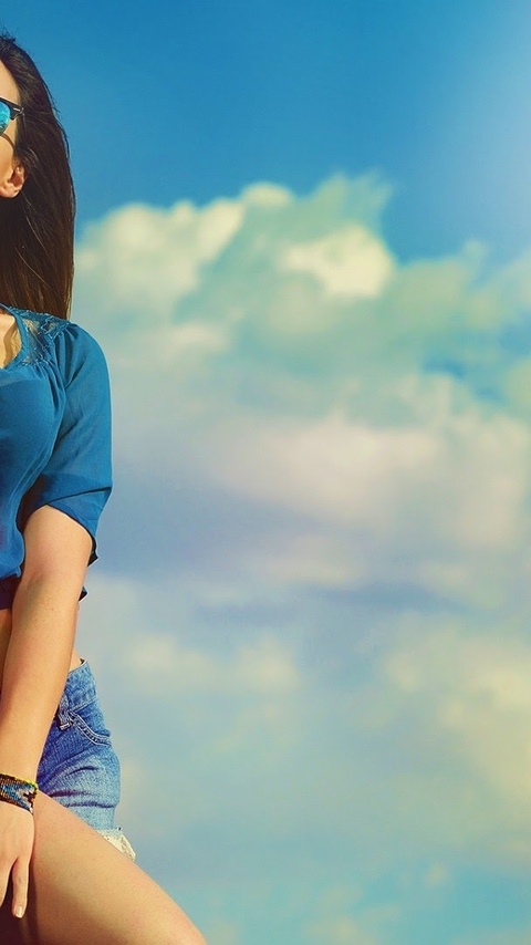 Image: Girl, brunette, blouse, shorts, glasses, sky, clouds