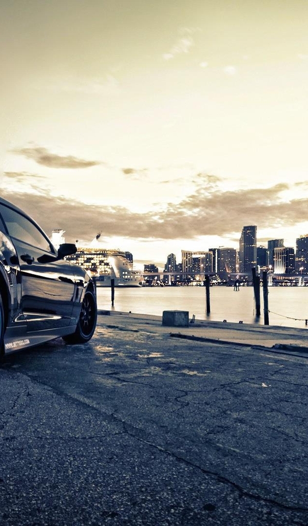 Image: Chevrolet Camaro, dark, stop lights, city, skyscrapers, buildings, river, embankment, gray sky
