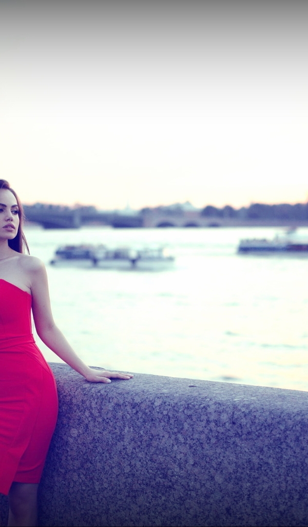 Image: Girl, brunette, long hair, red dress, figure, posing, river, water, waterfront, blurred background