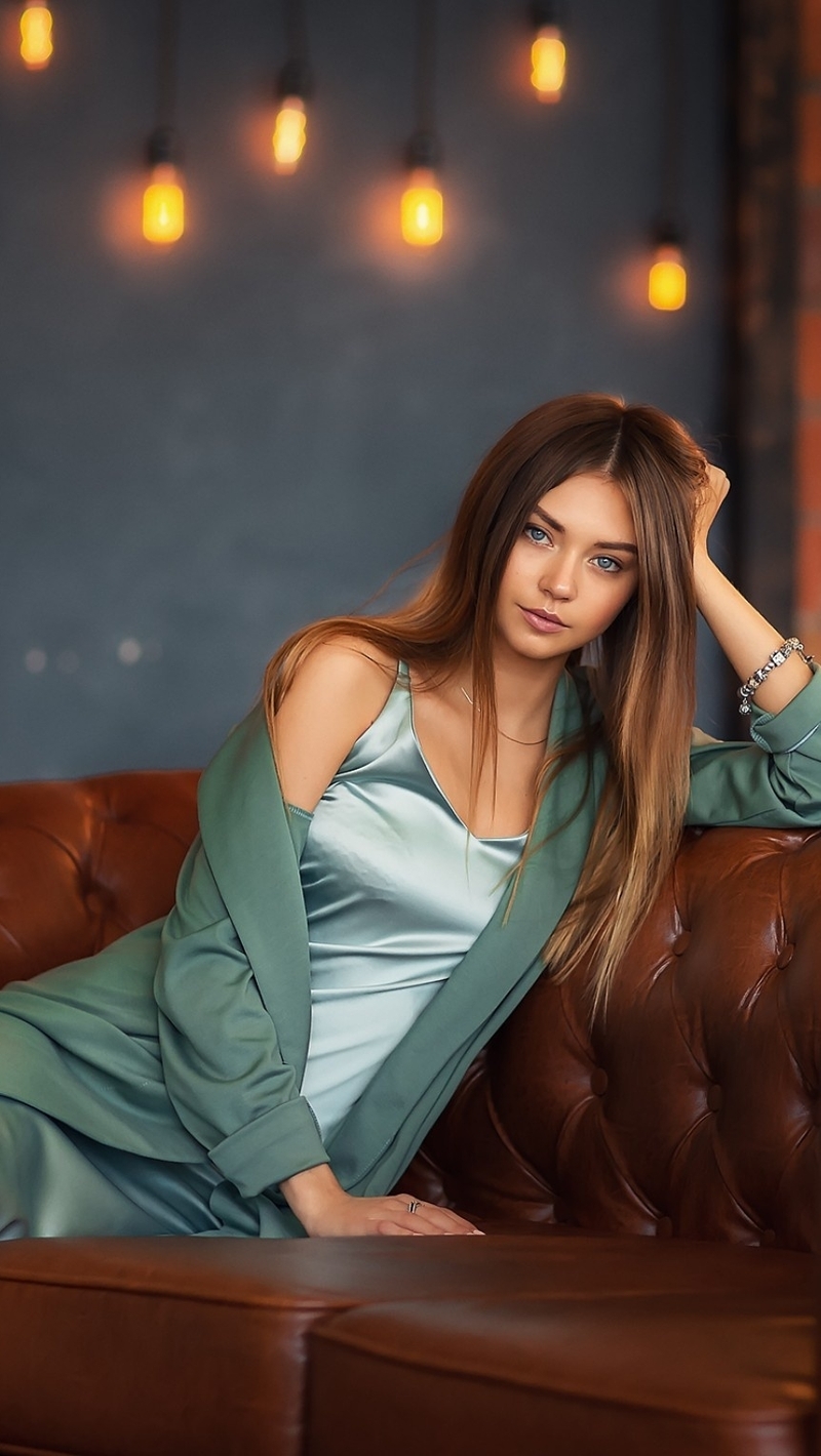 Image: Girl, long hair, pose, sofa, leather, lighting, lamp, wall, brick, Polina Kostyuk, model