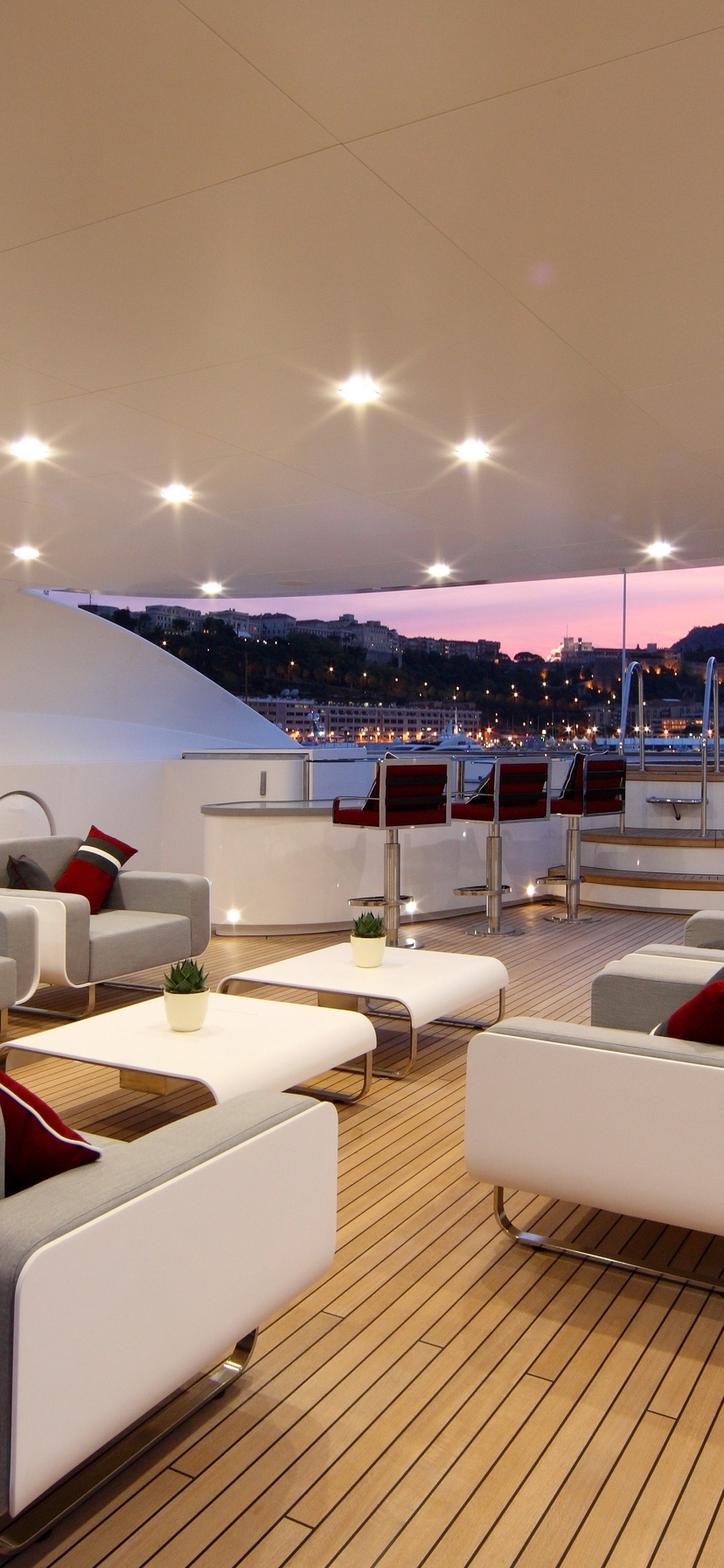 Image: A yacht, a couch, chairs, tables, bar stools, lights, night